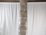 a tall glass vase with a lot of plastic wrap around it