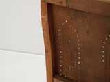 a wooden chair that has holes in the back of it