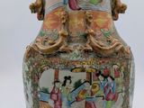 a large vase with a painting on it sitting on a table