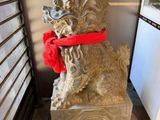 une statue représentant un chien avec un foulard rouge autour du cou