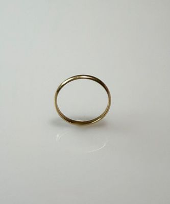 a close up of a gold ring on a white surface