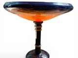 a blue and orange glass bowl sitting on a table