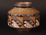 a vase with geometric designs on it on a black background