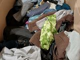 a cardboard box filled with clothes and clothing items