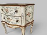 a small chest of drawers with floral designs on it