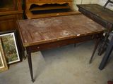a table with a wooden top and a wooden cabinet in the background