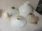 a white table with a white lamp and a white vase on it