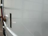 a white van parked in front of a building