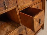 a wooden dresser with two drawers on top of it