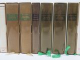 six books are lined up in a row on a white surface