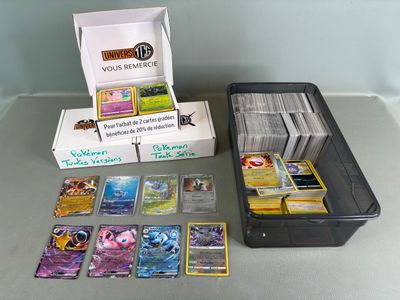 a box of pokemon cards sitting on a table next to a box of cards