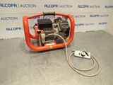 an orange machine with a hose attached to it