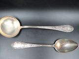 two spoons that are sitting on a table