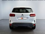 the rear end of a white citrole parked in a garage