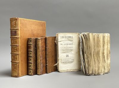 three old books sitting on top of each other next to each other