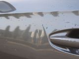 a close up of a car door handle with water droplets on it