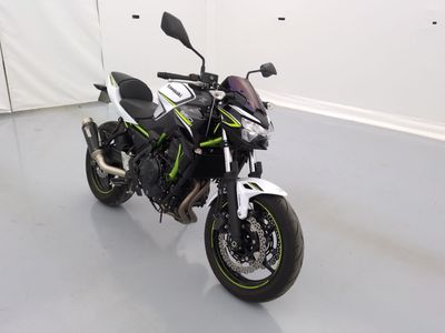 une photo d'une moto garée dans une pièce blanche