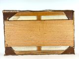 an old wooden box sitting on top of a white surface
