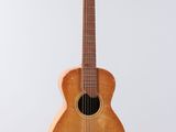 an old wooden guitar hanging from a string on a white background