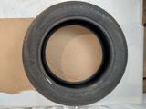 a tire that is sitting on top of a piece of cardboard