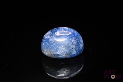 a picture of a blue and white marble on a black surface