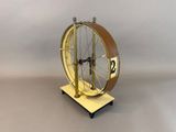 a clock that is sitting on a stand with a clock on it