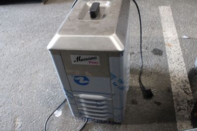une machine posée par terre à côté d'un parcmètre