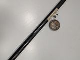 an image of a black and white pipe and a coin on a white surface
