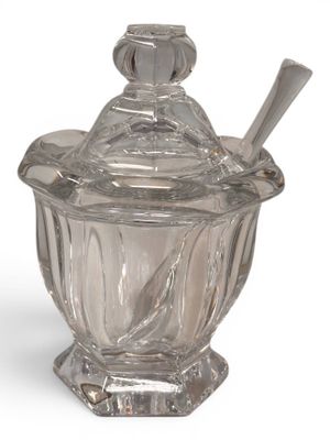 a glass jar with a spoon and spoon in it