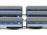two blue and silver train cars sitting side by side