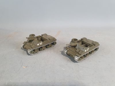 two toy tanks that are sitting on a table