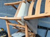 a wooden chair sitting on top of a pile of luggage