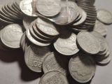 a pile of silver coins sitting on a table