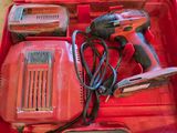 a red tool box with tools in it on the floor