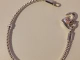 silver plated bracelet with a heart clasp and a ball chain
