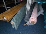 several rolls of fabric on the floor next to each other