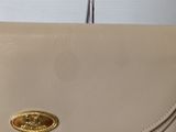 coach handbag in cream leather with a gold plated logo