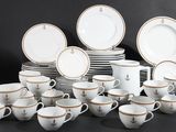 many cups and saucers that are sitting on a table