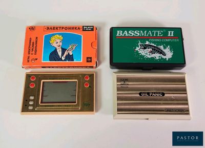 three electronic game consoles sitting next to each other on a table