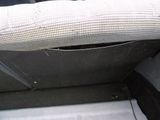 a seat in the back of a car with a hole in it