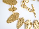 a gold necklace and bracelet with a gold chain