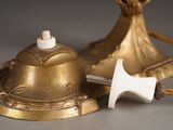 a gold bell and a white bell on a table
