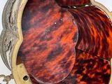 underside view of a tortoise shell purse with a chain