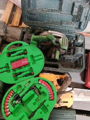 a green case with tools inside of it on a table