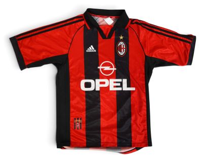 a close up of a red and black soccer shirt with a star on the chest