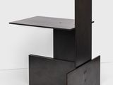 a close up of a black table with a drawer underneath it