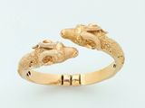 a gold ring that has two birds on it