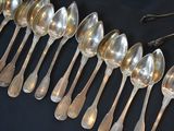 a lot of spoons that are lined up on a table