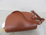 brown leather handbag with strap on a white surface