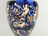 a blue vase with a blue handle on a white background